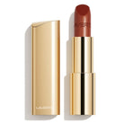 LAVERTU Lipstick Unique 15 Maxima Brown packshot featuring a warm brown shade with subtle bronze metallic shimmer, delivering full coverage colour in a luxurious gold case with a smooth satin matte finish.