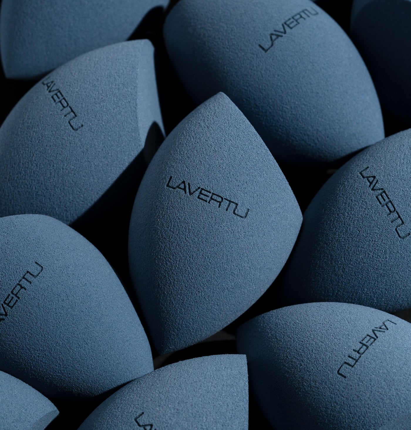 Multiple blue Lavertu makeup sponges with a soft velvety texture and signature logo.